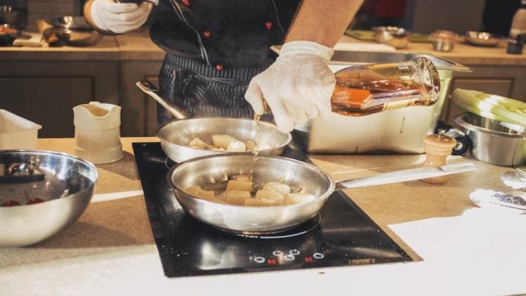 A person cooking using an induction cooker